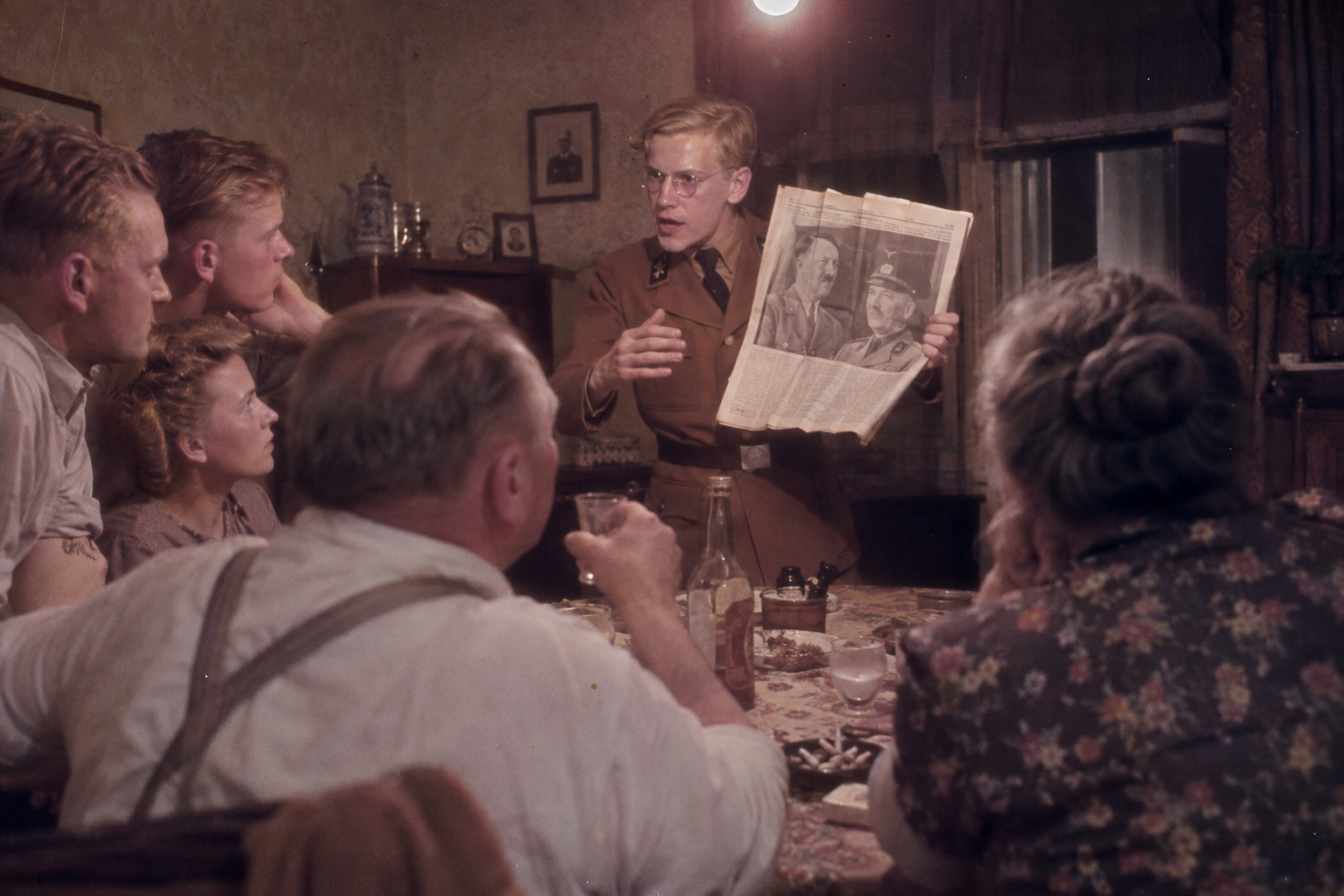 Baldur holds up the posed photograph
